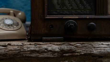 a close up of an old fashioned phone on a ledge